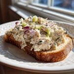 A generous serving of cottage cheese chicken salad piled high on a slice of toasted bread.