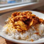 A serving of seasoned Instant Pot Chicken Shawarma Rice featuring shredded chicken over white rice.
