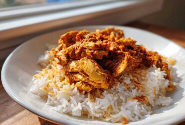 A serving of seasoned Instant Pot Chicken Shawarma Rice featuring shredded chicken over white rice.