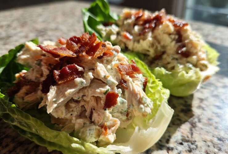Close-up of Keto Bacon Ranch Chicken Salad Lettuce Boats topped with crispy bacon bits.