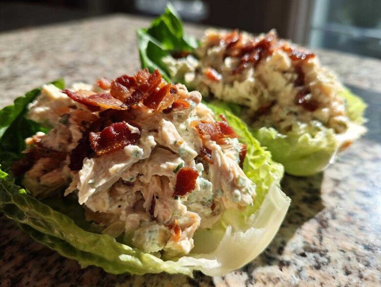Close-up of Keto Bacon Ranch Chicken Salad Lettuce Boats topped with crispy bacon bits.