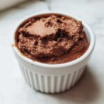 Close-up of rich, dark chocolate mousse texture in a white ramekin, perfect Keto Creamy Chocolate Cheesecake Mousse.