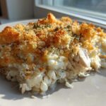 A serving of Cheesy Chicken and Rice Bake with a crispy, golden breadcrumb topping, served on a white plate.