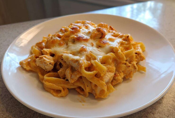 A serving of Creamy Cajun Chicken Alfredo Bake with melted, slightly browned cheese on top.
