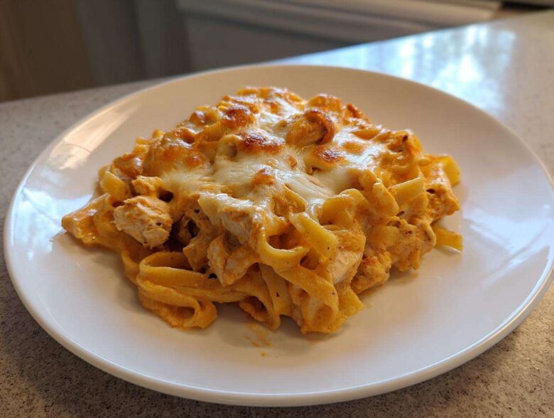 A serving of Creamy Cajun Chicken Alfredo Bake with melted, slightly browned cheese on top.
