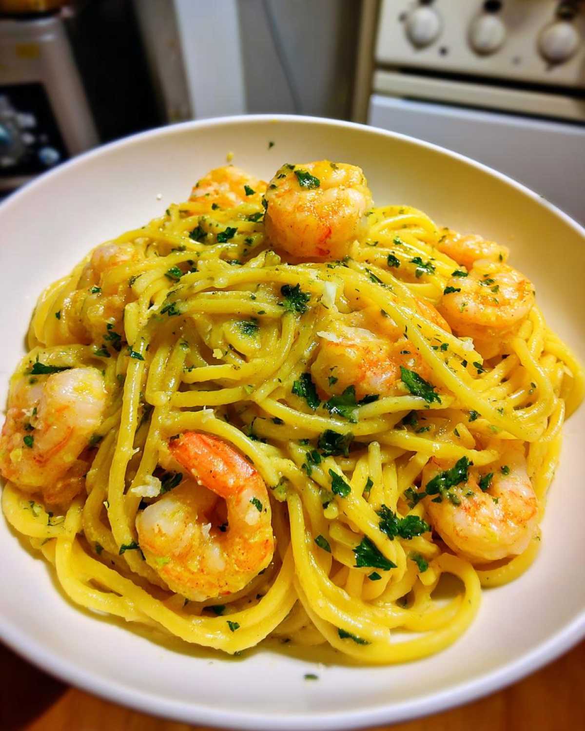 A close-up of Creamy Lemon Garlic Shrimp Pasta with plump shrimp and fresh parsley.