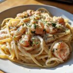 Close-up of a bowl of Garlic Butter Shrimp Pasta with Cream Sauce, topped with fresh parsley.