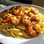 Close-up of Garlic Butter Shrimp with Pasta, featuring sautéed shrimp coated in garlic butter and parsley over linguine noodles.