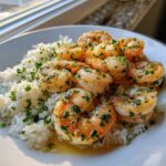 Close-up of a Garlic Butter Shrimp Rice Bowl featuring plump shrimp coated in garlic butter and herbs over white rice.