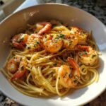 Close-up of Garlic Butter Shrimp with Pasta coated in a rich sauce and topped with parsley.