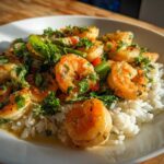 Close-up of Garlic Butter Shrimp with Rice and Veggies, glistening in sauce and topped with fresh parsley.