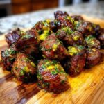 Close-up of perfectly seared Garlic Butter Steak Bites with Juicy Flavor, glistening with melted butter and herbs.