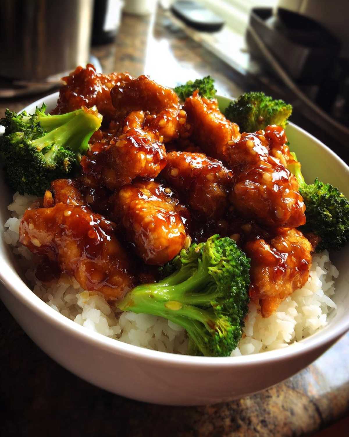Close-up of a Honey Soy Chicken Bowl Quick Dinner Idea featuring glazed chicken pieces and bright green broccoli over white rice.