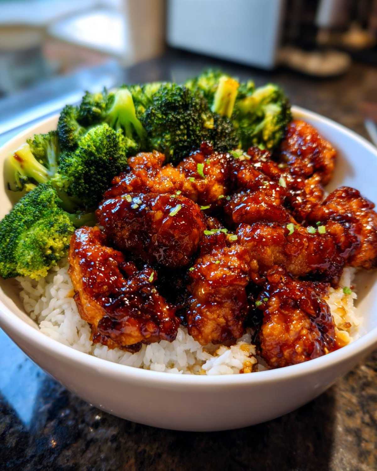 Close-up of a Honey Soy Chicken Bowl Quick Dinner Idea featuring glazed chicken pieces and bright green broccoli over white rice.