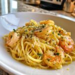 A close-up of Lemon Butter Shrimp Pasta Ready in 20 Minutes, featuring linguine tossed in a creamy sauce with large shrimp and parsley.